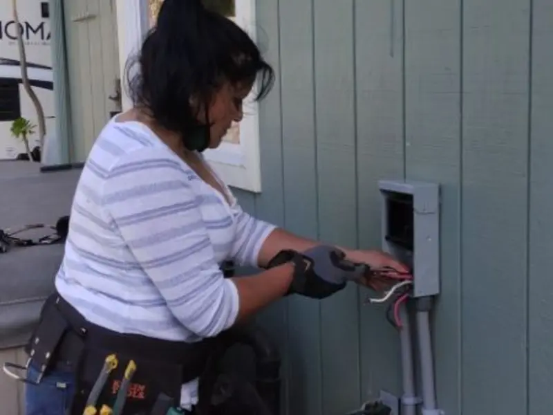 Licensed electrician wiring an exterior subpanel in Kingston